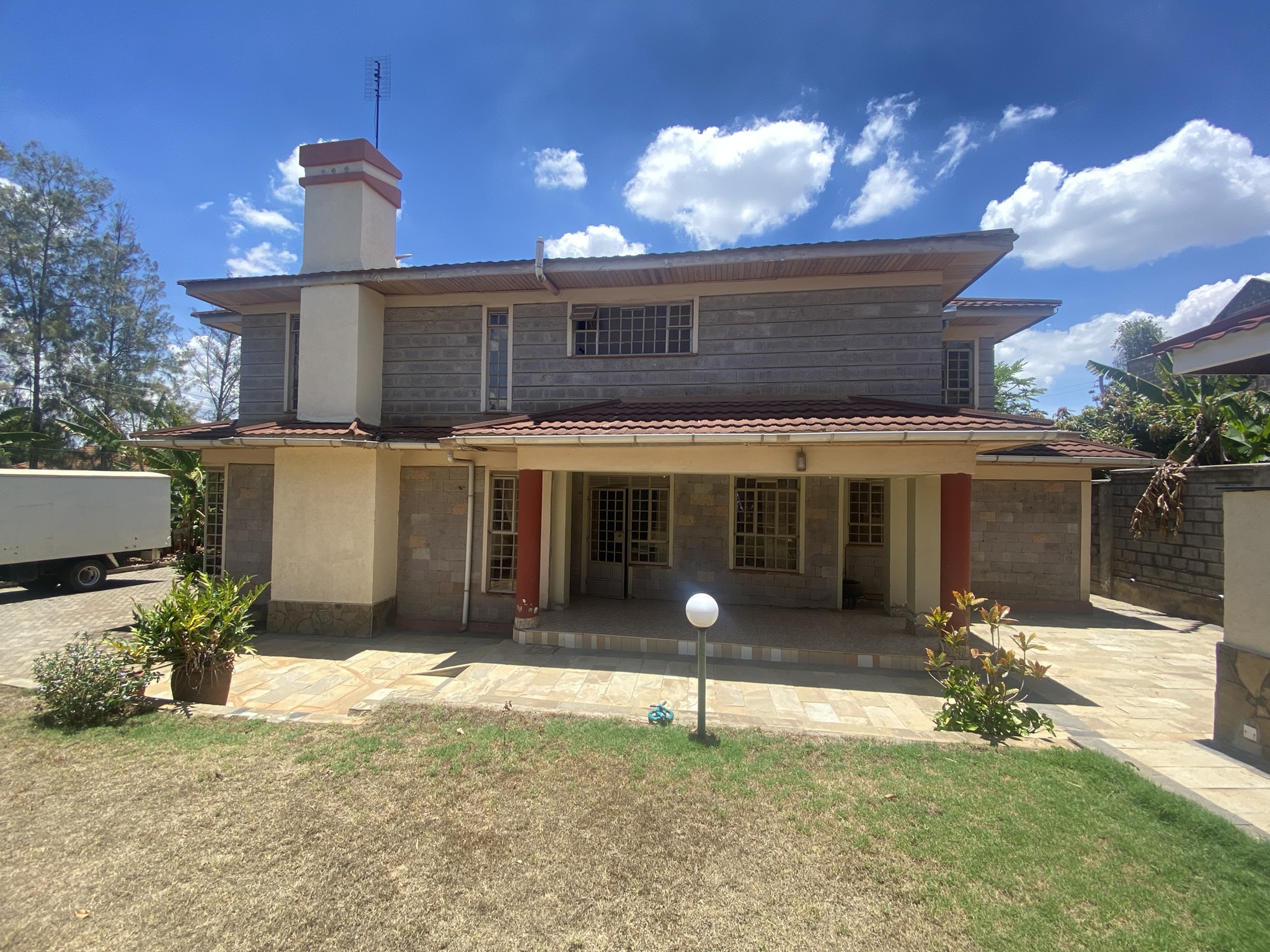 A  five bedroomed double storey residential house with a detached ablution block.