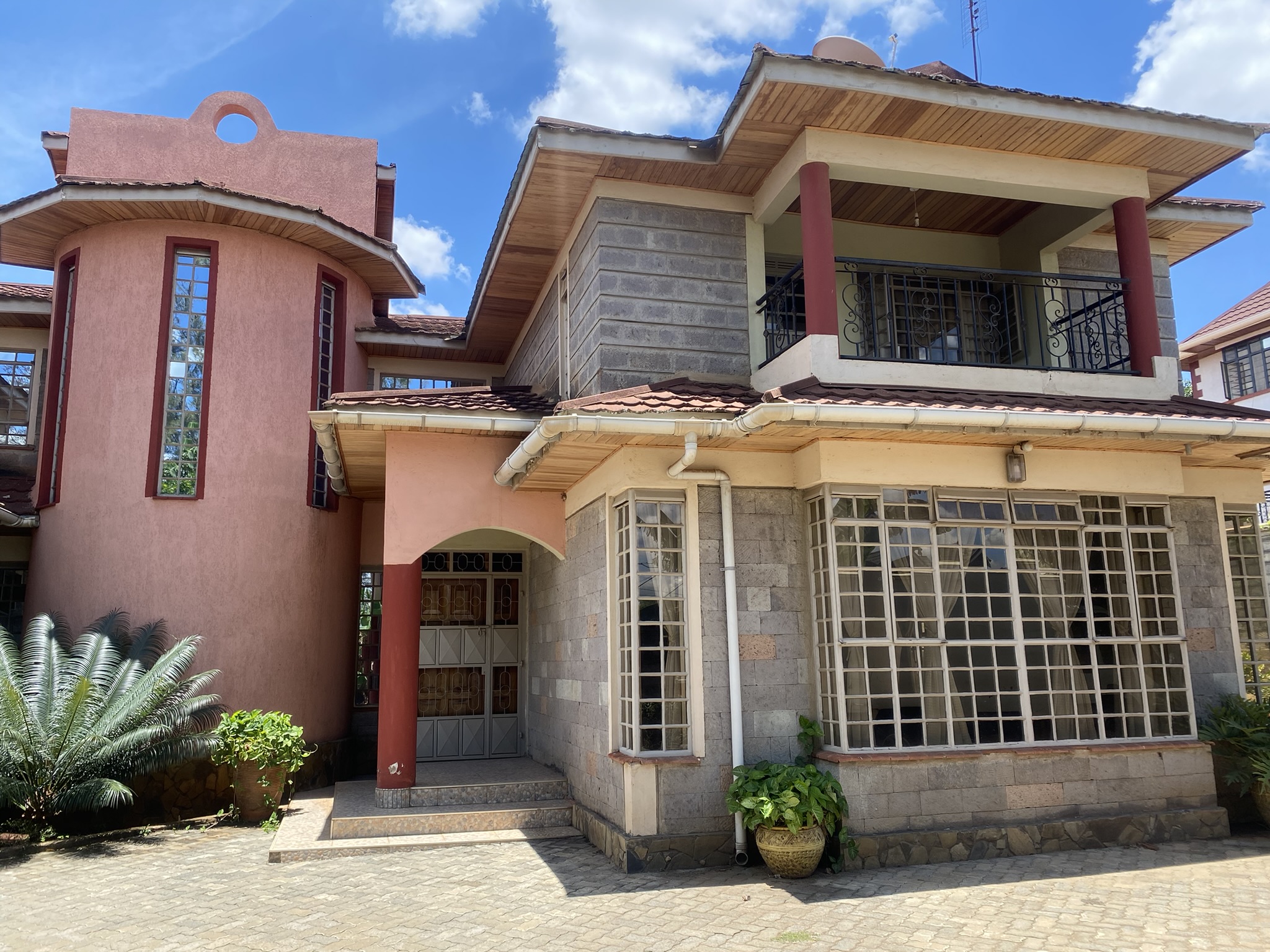 A  five bedroomed double storey residential house with a detached ablution block.