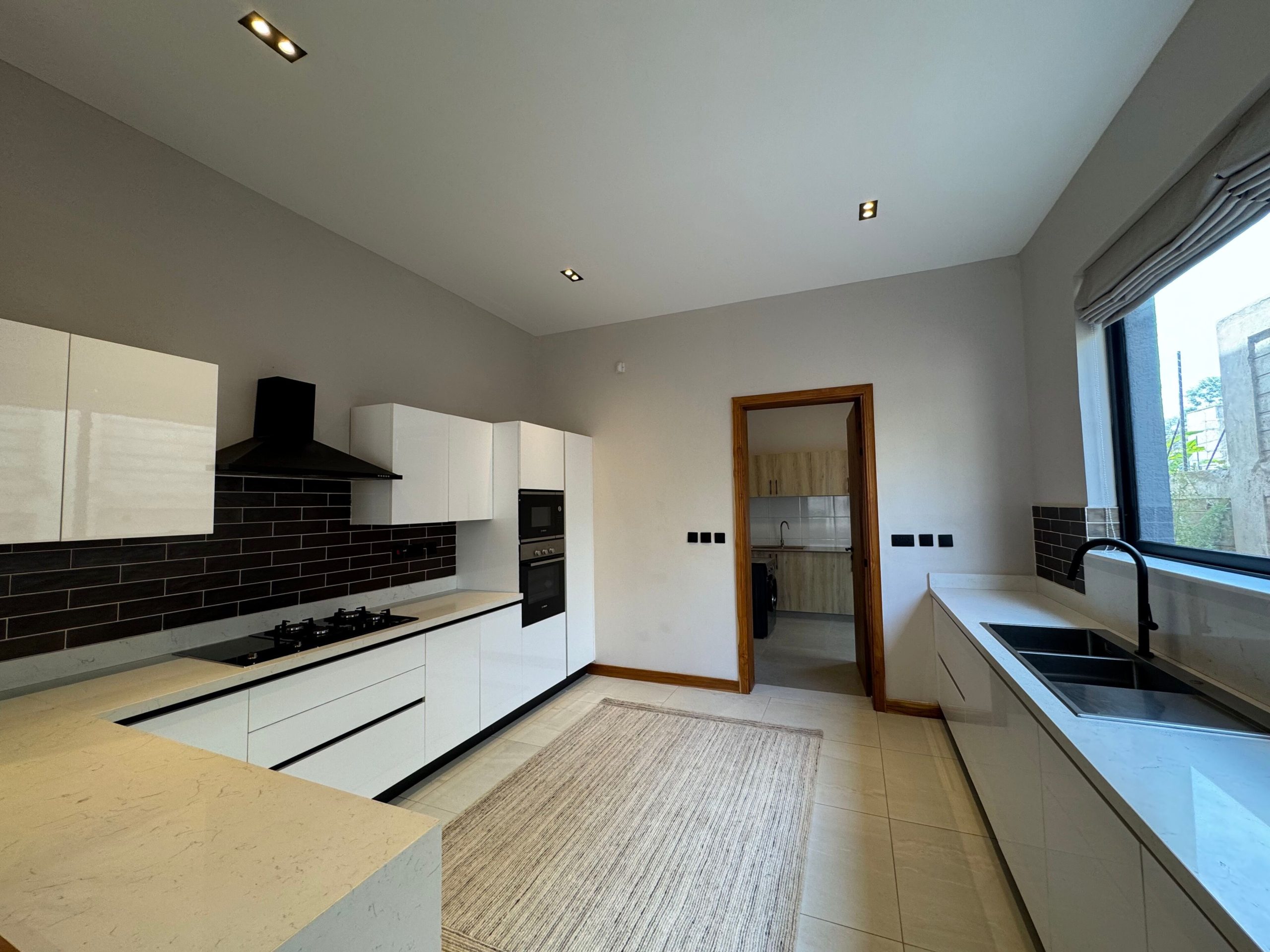 A newly built 4-bedroom villa offers contemporary living in a secure, gated compound