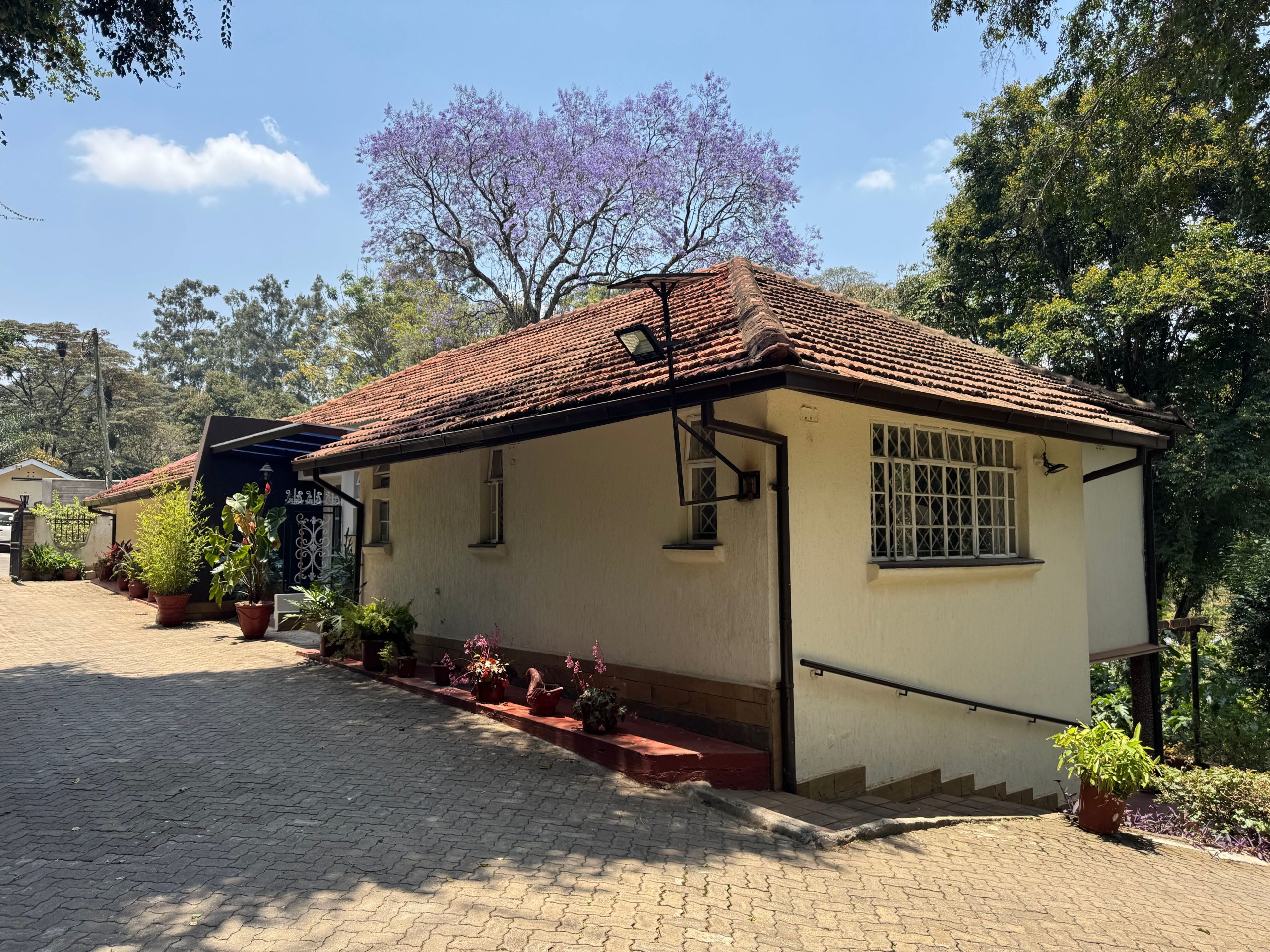 This charming house in Muthaiga exudes character and sits on an expansive, mature garden filled with lush greenery.